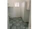 Spacious laundry room with tile flooring, a window, and built in storage at 1828 Casa Vista Dr, Las Vegas, NV 89146
