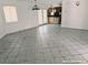 The spacious living room offers tile flooring, bright light and views of the kitchen at 1828 Casa Vista Dr, Las Vegas, NV 89146