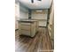 Large walk-in closet island featuring custom drawers, shelving, and hardwood floors at 1828 Casa Vista Dr, Las Vegas, NV 89146