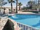 A private backyard pool is surrounded by desert landscaping, rocks and features a diving board at 1828 Casa Vista Dr, Las Vegas, NV 89146