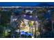 Night aerial of a beautiful home with a pool, lights and a view of the city at 2041 Troon Dr, Henderson, NV 89074