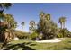 Beautiful backyard with mature trees and manicured lawn, perfect for outdoor relaxation at 2041 Troon Dr, Henderson, NV 89074