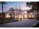 Charming two-story home featuring arched windows, a tile roof, and a beautifully landscaped front yard at 2041 Troon Dr, Henderson, NV 89074