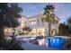 Luxury home featuring lush landscaping, a backyard swimming pool and a second story balcony at 2041 Troon Dr, Henderson, NV 89074