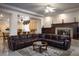 Cozy living room with a fireplace and comfortable leather seating at 2041 Troon Dr, Henderson, NV 89074
