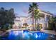 Backyard oasis featuring a sparkling pool, mature palm trees, and an expansive patio for entertaining at 2041 Troon Dr, Henderson, NV 89074