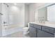 Bathroom featuring a combined tub and shower, plus a single sink vanity with modern fixtures at 2509 Silent View Ave, Henderson, NV 89044