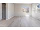 A well-lit bedroom featuring wood-look floors and multiple windows at 2509 Silent View Ave, Henderson, NV 89044