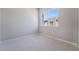 Small carpeted bedroom featuring a single window with a view of exterior building at 2509 Silent View Ave, Henderson, NV 89044