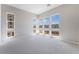 Bright bedroom features large windows with neighborhood views and neutral carpet at 2509 Silent View Ave, Henderson, NV 89044