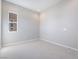 Neutral bedroom featuring carpeted floors, a window letting in natural light, and simple, clean walls at 2509 Silent View Ave, Henderson, NV 89044