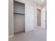 Carpeted bedroom featuring an open closet with hanging rack and sliding doors at 2509 Silent View Ave, Henderson, NV 89044