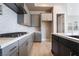 A contemporary kitchen with gray cabinets, a white backsplash, and a cooktop on a white countertop at 2509 Silent View Ave, Henderson, NV 89044