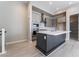 Stylish kitchen features gray cabinets, stainless appliances, and a spacious island with white countertop at 2509 Silent View Ave, Henderson, NV 89044