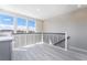 Bright loft area with sleek railings, hardwood floors, and multiple windows offering neighborhood views at 2509 Silent View Ave, Henderson, NV 89044