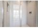 Close-up of bright white tiled glass shower enclosure featuring sleek hardware at 2509 Silent View Ave, Henderson, NV 89044