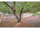 A beautiful, spacious backyard featuring desert landscaping, neutral-colored stucco, and a small concrete patio at 2526 Evansville Ave, Henderson, NV 89052