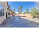 A large backyard patio offers outdoor seating and views of mature palm trees at 2566 Antique Blossom Ave, Henderson, NV 89052