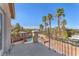 Balcony view of the pool area with multiple palm trees and desert landscape at 2566 Antique Blossom Ave, Henderson, NV 89052
