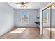 Bedroom features a window with shutters, mirrored closet doors, and a ceiling fan with light at 2566 Antique Blossom Ave, Henderson, NV 89052