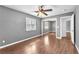 A bedroom featuring a mirrored closet, wood-look flooring, and a window at 2566 Antique Blossom Ave, Henderson, NV 89052