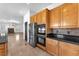 Modern kitchen with stainless steel appliances, granite countertops, and light wood cabinets at 2566 Antique Blossom Ave, Henderson, NV 89052