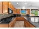 Gourmet kitchen showcasing stainless steel appliances, granite countertops and backsplash, and a central island at 2566 Antique Blossom Ave, Henderson, NV 89052