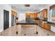 Spacious kitchen features custom cabinets, stainless steel appliances, granite countertops and a large island at 2566 Antique Blossom Ave, Henderson, NV 89052