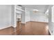 A spacious living area with hardwood floors, white walls, and an ornate chandelier at 2566 Antique Blossom Ave, Henderson, NV 89052