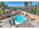 Backyard pool area featuring a slide, pool house and lounge seating at 2566 Antique Blossom Ave, Henderson, NV 89052