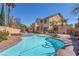 Resort-style backyard featuring a private pool, spa, built-in bar and lush landscaping at 2566 Antique Blossom Ave, Henderson, NV 89052