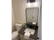 Powder room featuring a modern sink, dark fixtures, and a decorative mirror and vanity at 2621 Adelante Ave # 102, Las Vegas, NV 89106