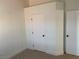 Bedroom features two closets and neutral carpeting at 2621 Adelante Ave # 102, Las Vegas, NV 89106