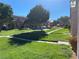 Well maintained community lawn with mature trees and a playground for community residents at 2621 Adelante Ave # 102, Las Vegas, NV 89106