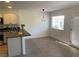 Dining area featuring a modern light fixture and natural light from the window at 2621 Adelante Ave # 102, Las Vegas, NV 89106