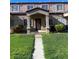 Inviting townhome with a covered front porch and well-maintained lawn at 2621 Adelante Ave # 102, Las Vegas, NV 89106