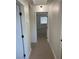 Neutral hallway featuring carpet flooring that leads to bedrooms and other parts of the home at 2621 Adelante Ave # 102, Las Vegas, NV 89106