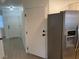 Galley kitchen with stainless steel appliances, ample pantry space, and luxury vinyl plank flooring at 2621 Adelante Ave # 102, Las Vegas, NV 89106