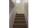 Carpeted staircase with white railing leading to the upper level at 2621 Adelante Ave # 102, Las Vegas, NV 89106