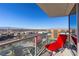 Balcony featuring stunning cityscape views, with an outdoor seating area and glass railings at 2700 Las Vegas Blvd # 1202, Las Vegas, NV 89109