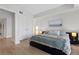 Bright bedroom features light wood floors, king bed with gray bedding and a modern, minimalist design at 2700 Las Vegas Blvd # 1202, Las Vegas, NV 89109