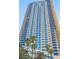 Modern, towering high-rise with blue-tinted windows, many balconies, and palm trees for a tropical feel at 2700 Las Vegas Blvd # 1202, Las Vegas, NV 89109