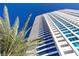 Upscale high-rise with sleek design, multiple balconies, and palm trees offering a vibrant city lifestyle at 2700 Las Vegas Blvd # 1202, Las Vegas, NV 89109
