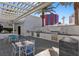 Beautiful outdoor kitchen with built-in grill, marble backsplash, and seating, perfect for entertaining guests at 2700 Las Vegas Blvd # 1202, Las Vegas, NV 89109