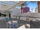 Outdoor kitchen area with marble tile, multiple grills and dining area at 2700 Las Vegas Blvd # 1202, Las Vegas, NV 89109