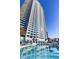 Luxurious condo building has a pool with inviting turquoise water and lounge seating for relaxation at 2700 Las Vegas Blvd # 1202, Las Vegas, NV 89109