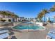 Gorgeous community pool with blue lounge chairs, palm trees, and stunning architecture in Las Vegas at 2700 Las Vegas Blvd # 1202, Las Vegas, NV 89109