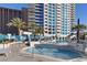Luxurious high-rise community pool featuring palm trees and multiple lounge areas under the beautiful Las Vegas sky at 2700 Las Vegas Blvd # 1202, Las Vegas, NV 89109