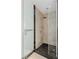 Modern shower with black tiled floor, marble walls, and glass door at 2700 Las Vegas Blvd # 1202, Las Vegas, NV 89109