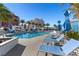 Resort-style pool area with palm trees, blue umbrellas, and inviting lounge chairs at 2700 Las Vegas Blvd # 1202, Las Vegas, NV 89109